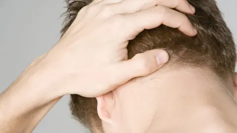 Getty Images Man head in hands