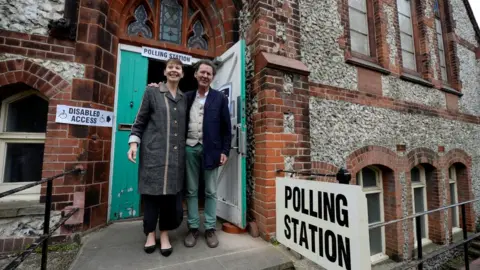 Reuters Caroline Lucas, co-leader of Britain"s Green Party, arrives with her husband Richard Savage to vote in Brighton