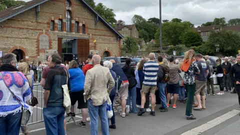 PA Media/Connie Evans Crowds waited outside the venue in Frome