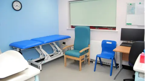Kettering General Hospital Trust Consultation room with chairs and couch