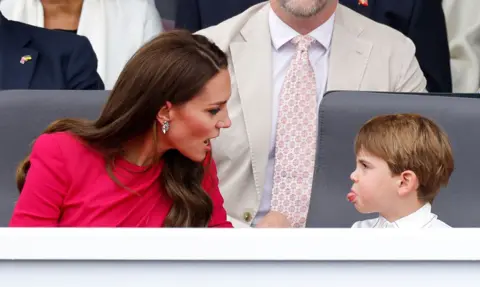 Max Mumby Prince Louis of Cambridge sticks his tongue out at his mother Catherine, Duchess of Cambridge, as they attend the Platinum Pageant on The Mall