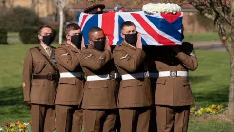 The coffin of Captain Sir Tom Moore is carried by members of the Armed Forces