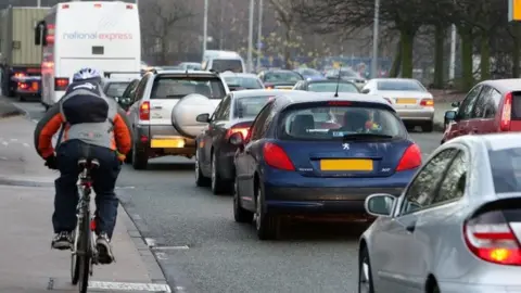 PA Cyclist and traffic in Manchester