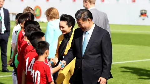 Getty Images President XI Jinping of China attends the Chinese German Football Summer Camp at Stadion am Wurfplatz on July 5, 2017 in Berlin, German