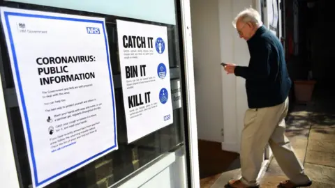 EPA An elderly man walks into a NHS centre testing for coronavirus London