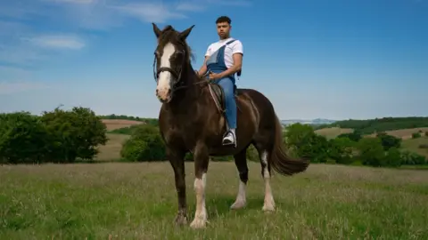 Keanan Keanan sitting on a horse in the countryside