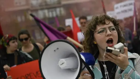 Getty Images A protester shouts slogans during a May Day rally marking International Workers' Day in Pristina, Kosovo.