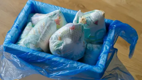 Getty Images A bin of nappies