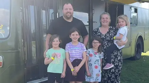 A family outside the bus