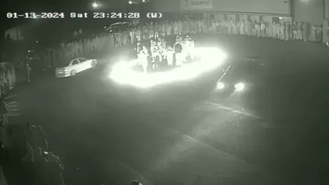 Gordon Tyler People standing in a ring of fire during a car meet