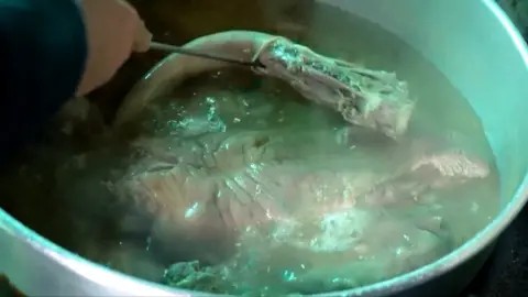 Dog meat being cooked