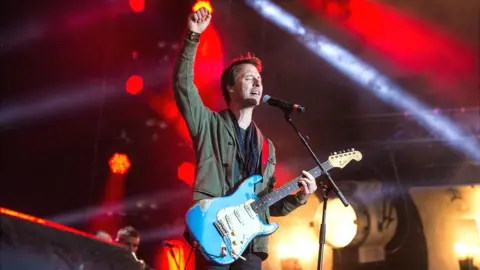 Getty Images Chesney Hawkes on stage with guitar