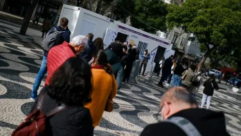 Reuters People queue for Covid tests in Lisbon, Portugal