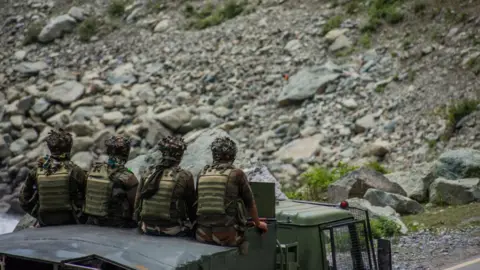 Getty Images Indian army convoy carrying reinforcements and supplies, drive towards Leh, on a highway bordering China.