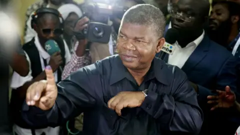 Getty Images MPLA (The People's Movement for the Liberation of Angola) presidential candidate Joao Lourenco shows his inked finger after voting
