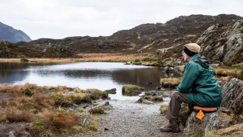 Cockermouth Mountain Rescue Team Andrew Nichol sitting by Innominate Tarn