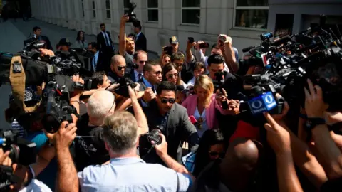 AFP via Getty Image Emma Coronel Aispuro, walks out of Brooklyn Federal Court on July 17, 2019