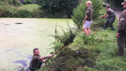 men clearing canal