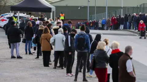 PA Media Queues outside a Liverpool testing site