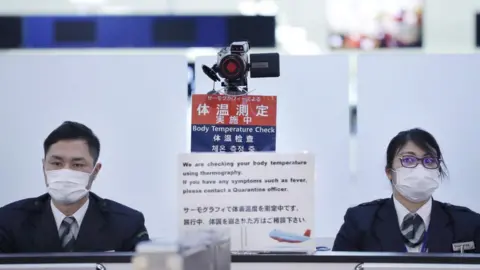 Getty Images Officers at Narita airport