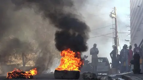 Getty Images Tyres on fire near the main prison of Port-au-Prince