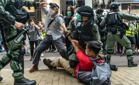 Anthony Kwan/Getty Images Pro-democracy supporters scuffle with riot police during a rally