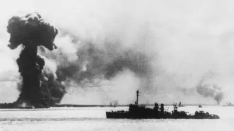 Getty Images An image from 1942 shows an Allied ship near a huge plume of smoke caused by a bomb