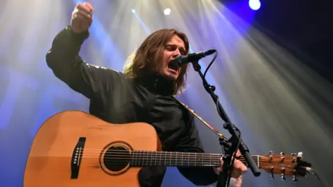 Getty Images Jamie Webster on stage at the Shepherds Bush Empire at an earlier tour date