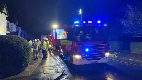 Essex Fire and Rescue Fire engines outside a house in Leigh-on-Sea