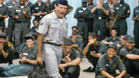 Getty Images Robin Williams in the film, surrounded by personnel