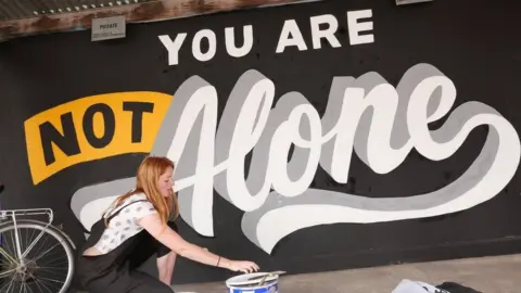 Plaster Communications Emily Joy Rich working on her mural for Upfest in Bristol