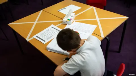 PA Media Boy sits at desk in classroom