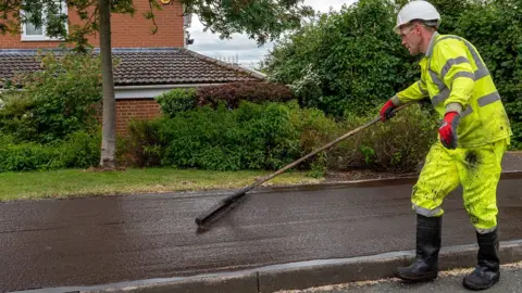 Rejuvo Man laying asphalt