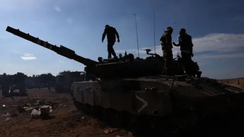 AFP Israeli soldiers are positioned outside kibbutz Beeri near the border with the Gaza Strip on October 17, 2023, in the aftermath of an October 7 attack by Palestinian militants.