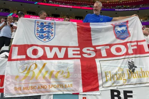 Bob Green Lowestoft flag at the at Al Bayt stadium in Qatar