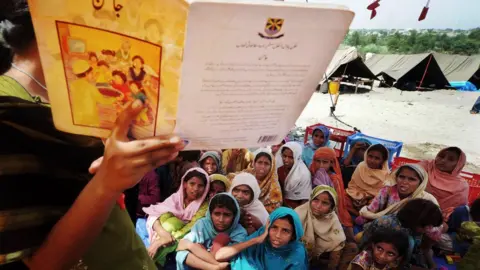 ARIF ALI / AFP Pakistani girls listen to a teacher at a makeshift tent school