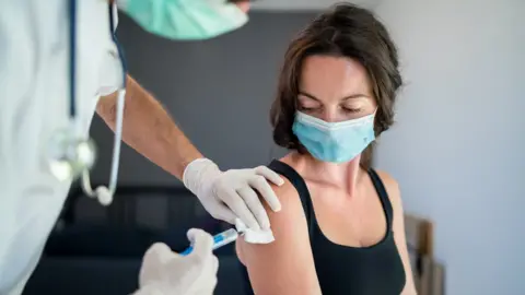 Halfpoint Images Person being vaccinated