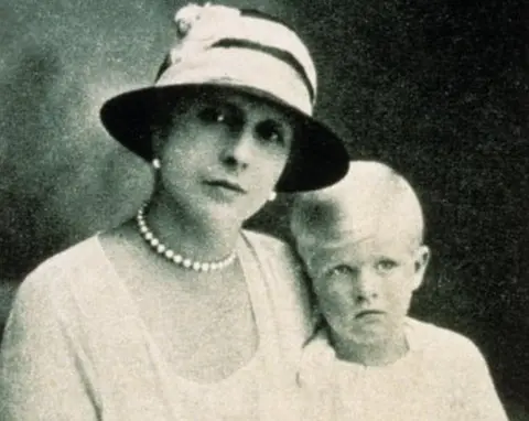 Topham/Topham Picturepoint/PA Princess Alice holds her toddler Prince Philip on her lap in a black and white portrait picture