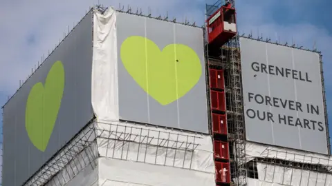 Getty Images grenfell tower covered with banner reading Grenfell forever in our hearts