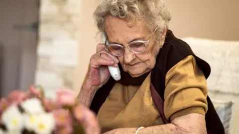 Getty Images Elderly woman on a landline phone