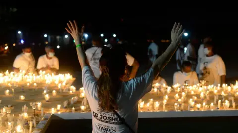 Getty Images Members of Synagogue Church of All Nations (SCOAN) hold a candlelight procession for TB Joshua in Lagos, Nigeria - Monday 5 July 2021