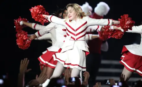 Inpho Madonna performs on stage with dancers in Nice southeastern France, as part of her MDNA world tour