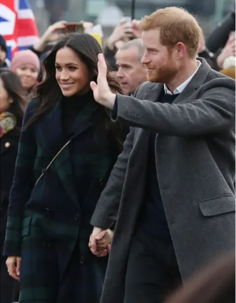 PA Prince Harry and Meghan Markle during a walkabout on the esplanade at Edinburgh Castle, during their visit to Scotland.