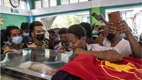 Getty Images Family members and relatives attend the funeral ceremony of 13 year-old Sai Wai Yan, who was shot dead while playing outside his house in Yangon