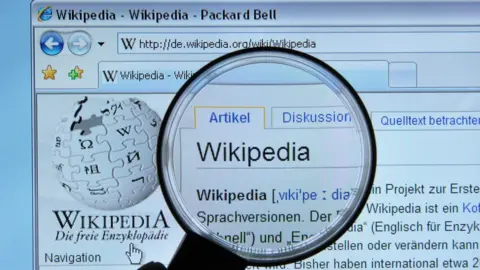 KAREN BLEIER/AFP/Getty Images Picture of Wikipedia homepage and a magnifying glass