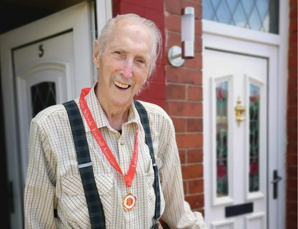 Burnley Council John Zelly proudly wears his medal