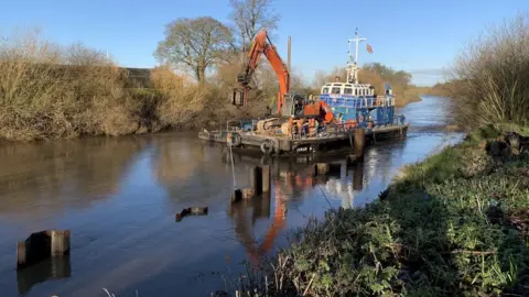 Environment Agency Specialist boat at work on the river Aire