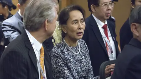 Getty Images Myanmar"s State Counsellor Aung San Suu Kyi departs after her speech at the ASEAN Business and Investment Summit