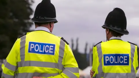 Getty Images Two police officers facing backs to camera