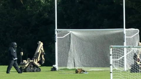 Pacemaker bomb disposal robots next to goalposts